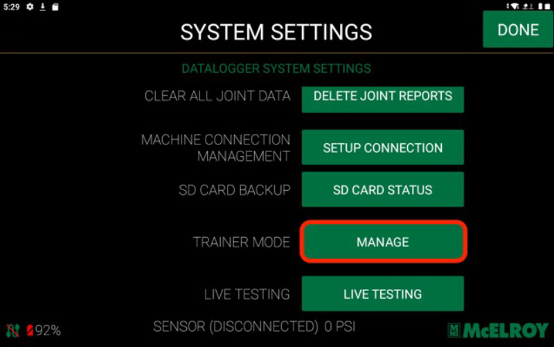 A system settings screen with options like Delete Joint Reports, Setup Connection, SD Card Status, Manage Trainer Mode (highlighted), and Live Testing. The battery indicator shows 92%. McElroy logo is in the bottom right corner.