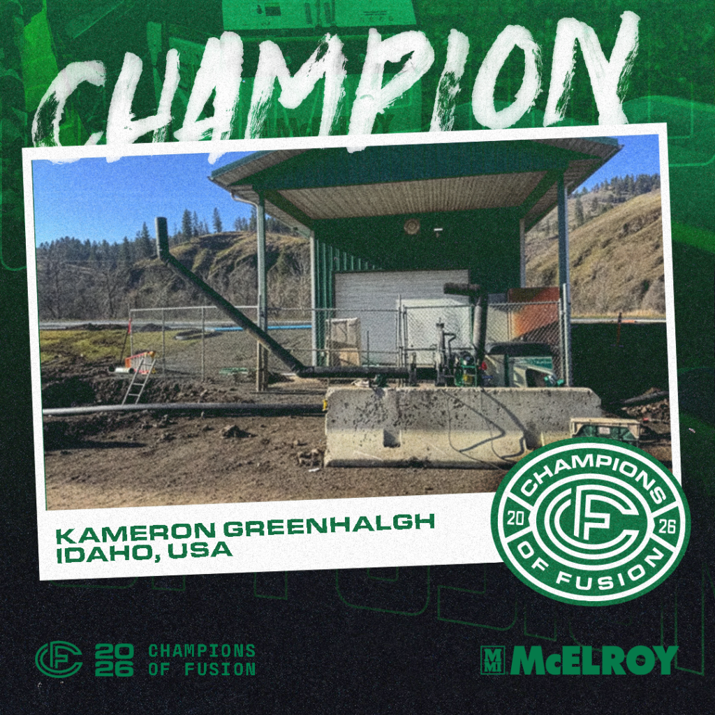 A fenced industrial site with equipment and a green metal-roofed shelter sits in a rural, hilly landscape. Overlaid text announces Kameron Greenhalgh as a Champion of Fusion 2026 from Idaho, USA.
